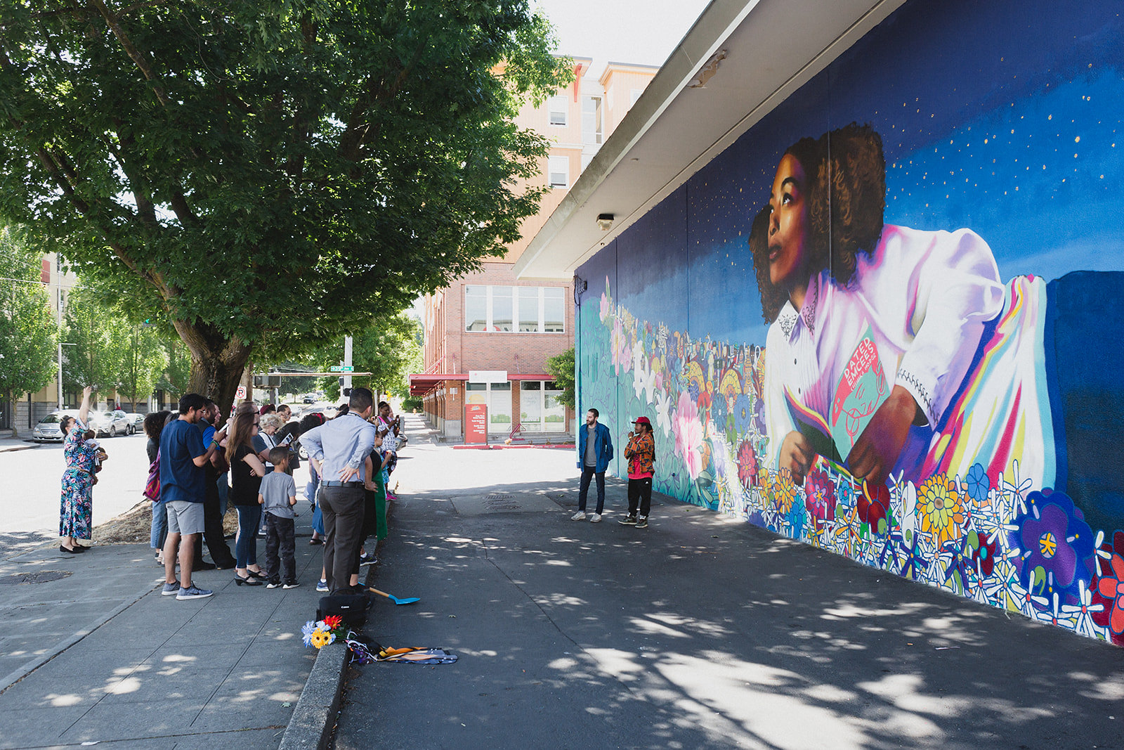 Header Right Image Group gathering in front of mural