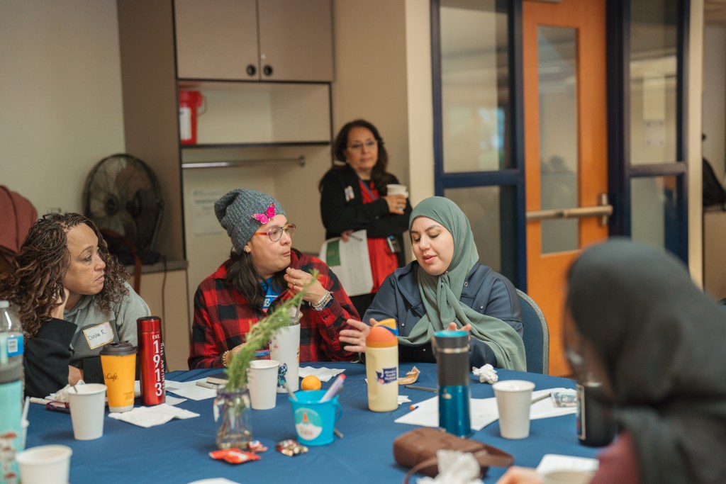 Providers sitting around a table talking.