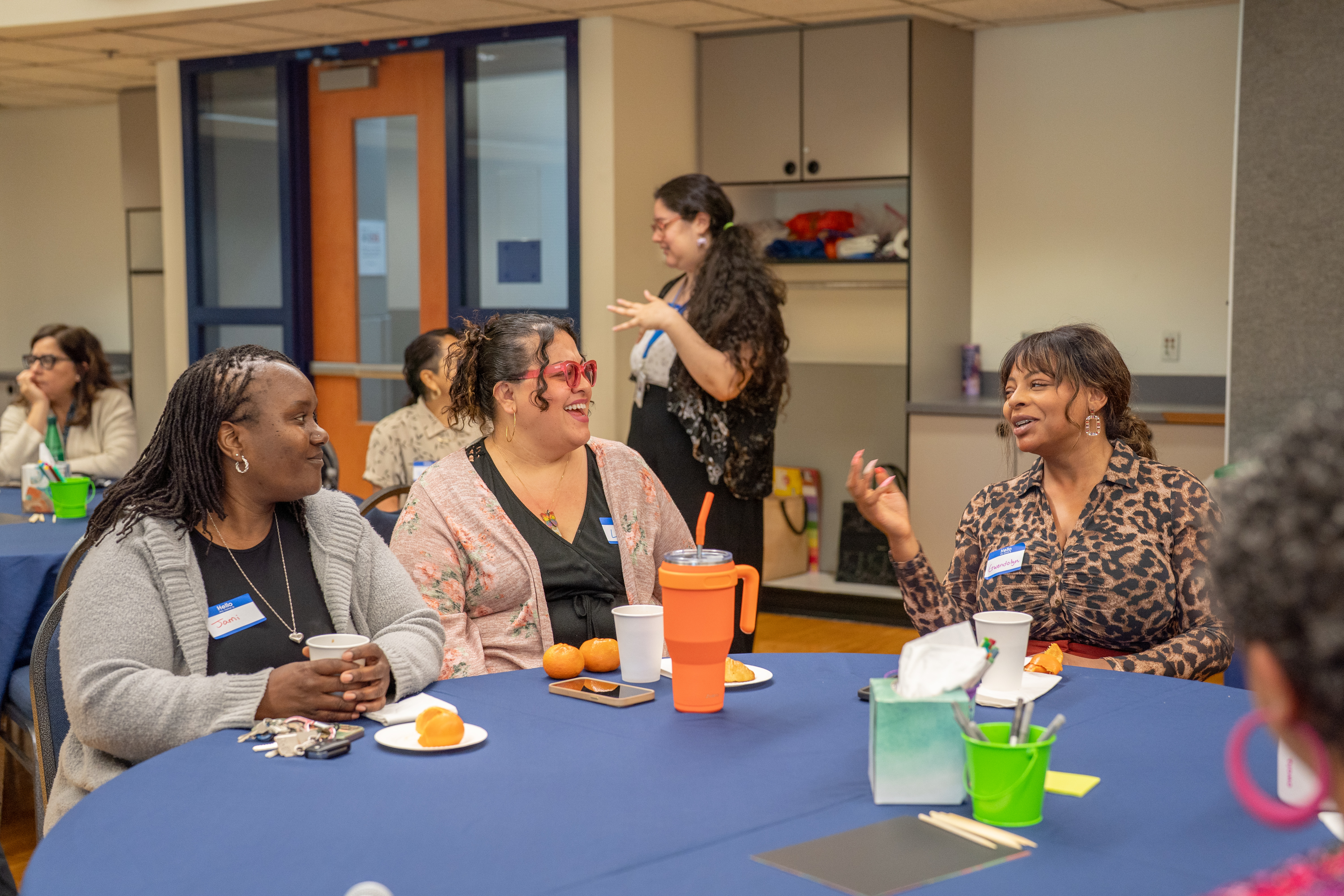 Providers sitting and talking at a table during a workshop.