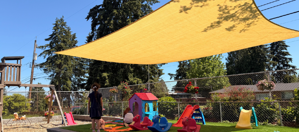 Sun shade providing shade over an outdoor play area