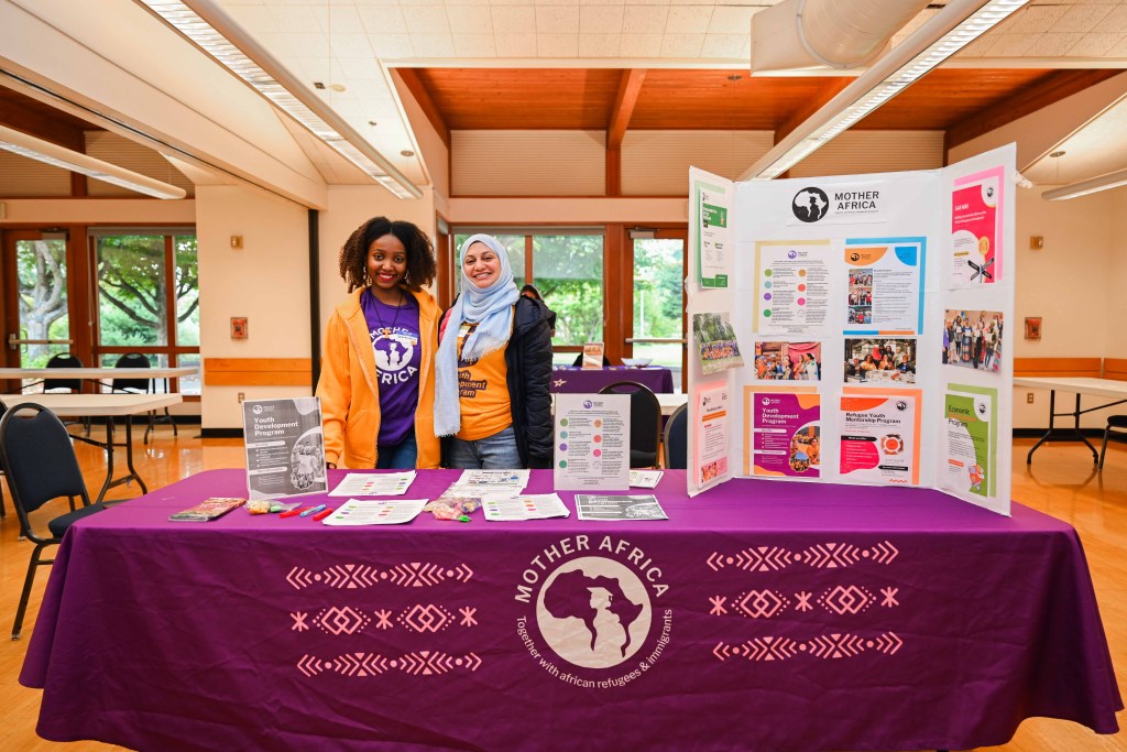 Two community partners tabling at a resource fair.