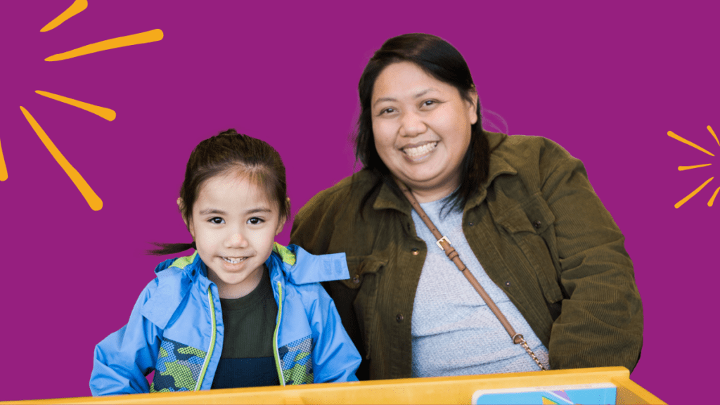 Caregiver and child smiling at the camera