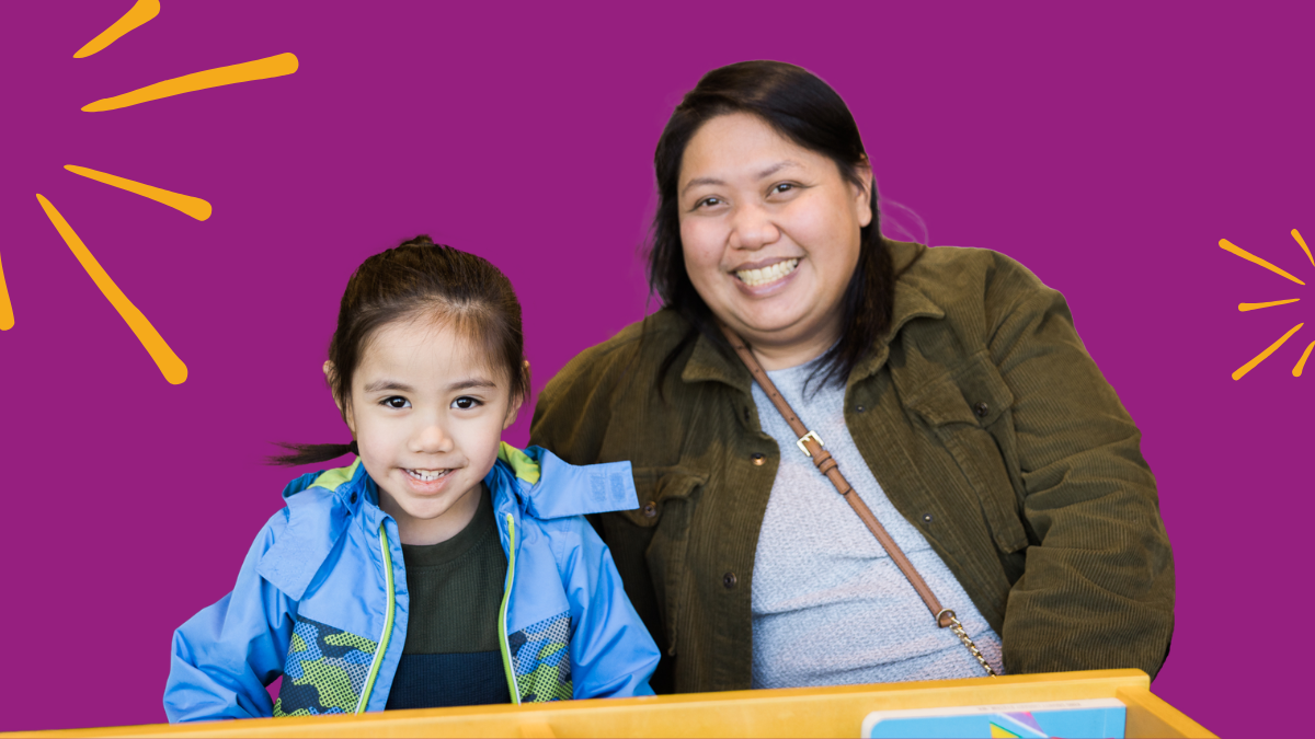 Caregiver and child smiling at the camera